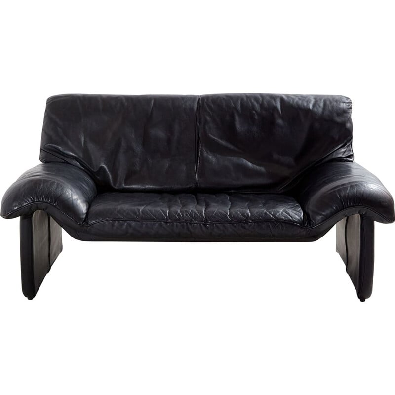 Vintage two-seater black leather sofa